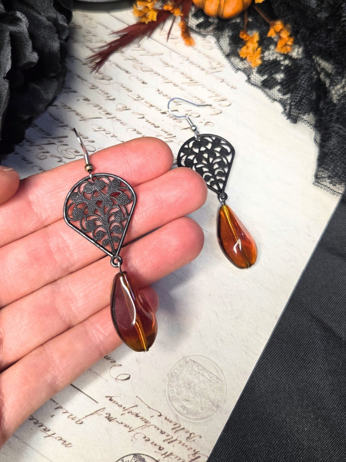 Black filigree orange earrings