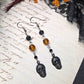 Black skull orange earrings