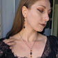 Black skull orange earrings